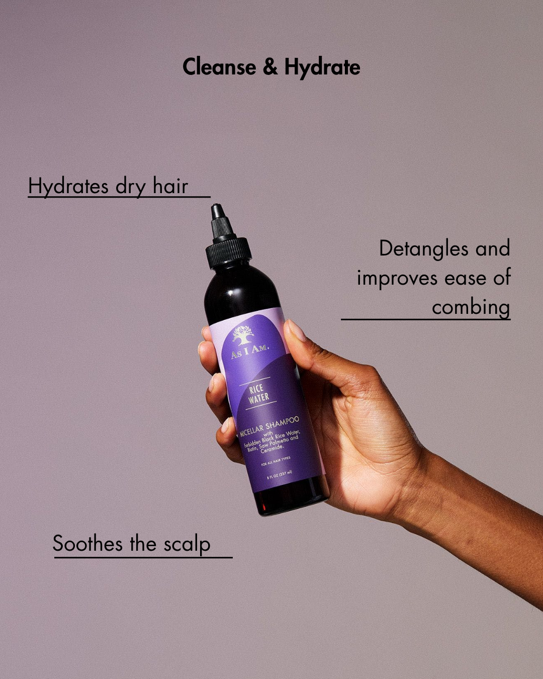 Hand hält eine lila Shampoo-Flasche mit Text über Haarpflege Vorteile auf einem grauen Hintergrund